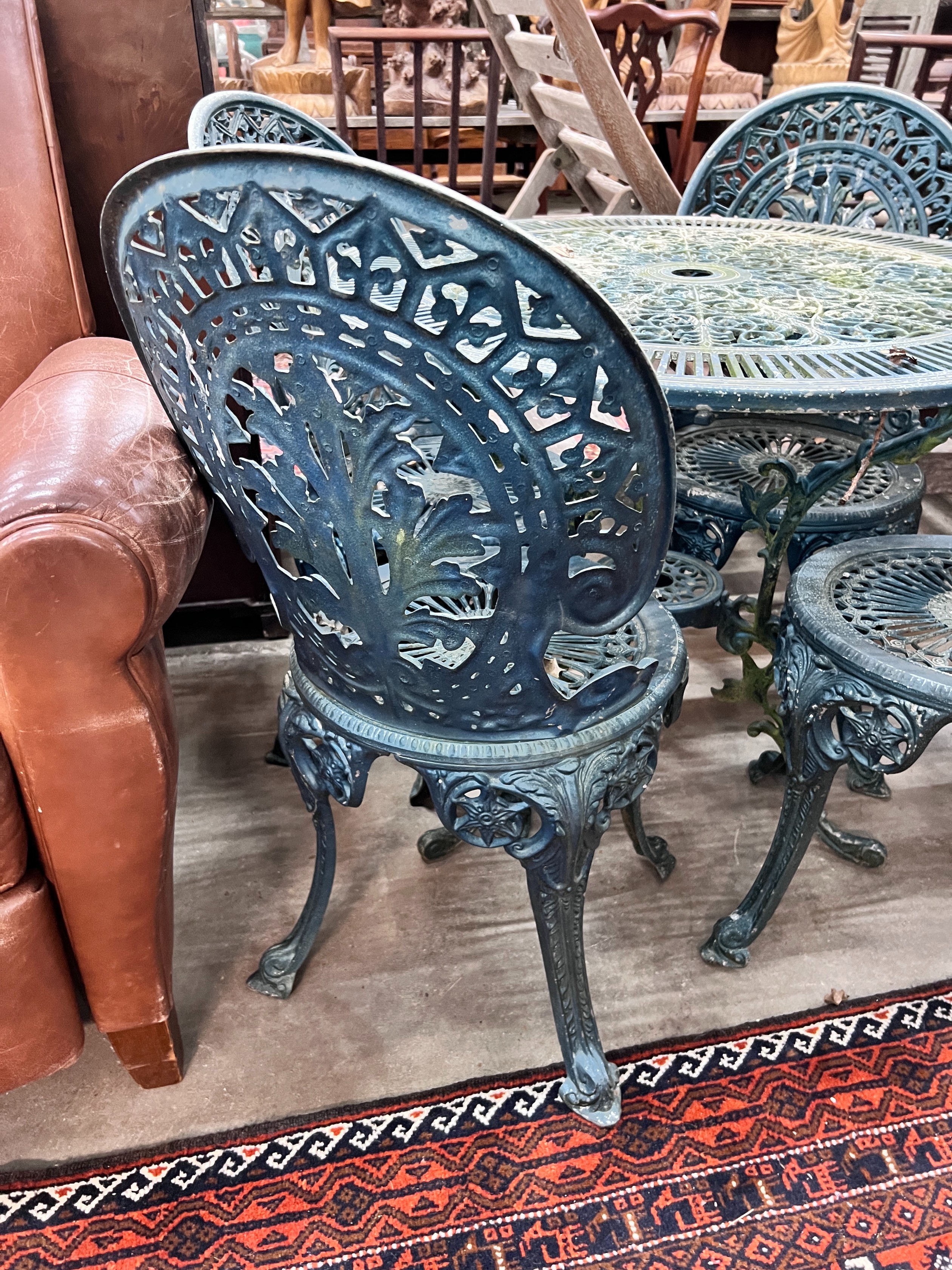 A Victorian style circular aluminium table, diameter 80cm, height 69cm and four matching chairs *Please note the sale commences at 9am.